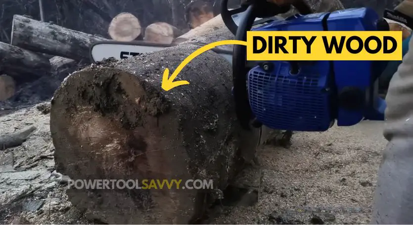 cutting dirty wood with chainsaw