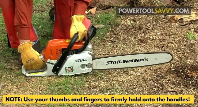 demonstrating how to hold a chainsaw the right way.
