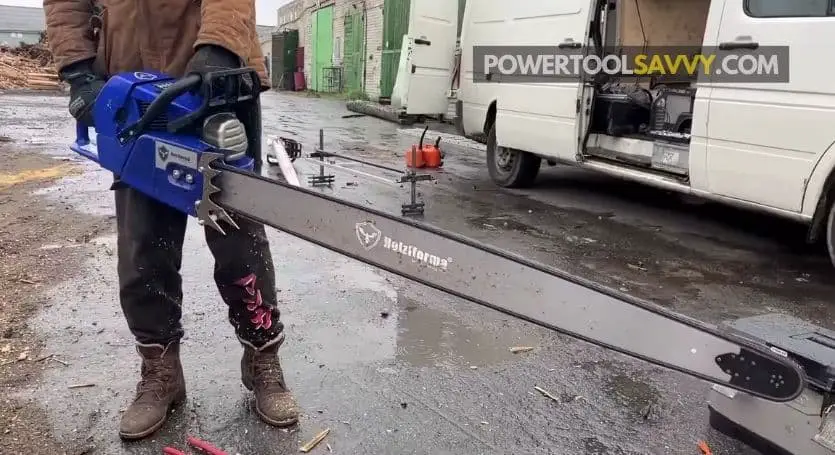 holding a chainsaw with a 48-inch bar