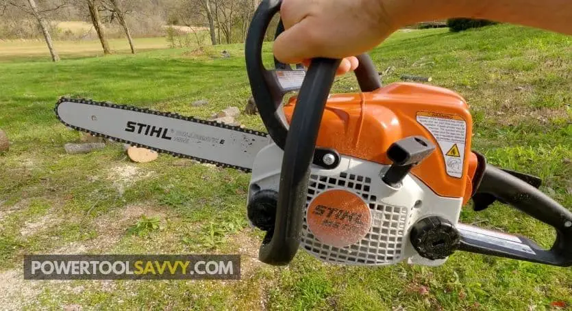 holding a rear-handle chainsaw